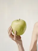 Hand houdt een groene appel vast