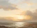 Schilderij van een gouden zonsondergang boven de oceaan