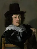 Portret van een zittende jonge man met een zwarte hoed van Frans Hals: portret met man, zwarte hoed, kraag en stoel, in donkerbruin en zwart