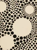 Abstract patroon van zwarte cirkels van verschillende grootte op een crème achtergrond