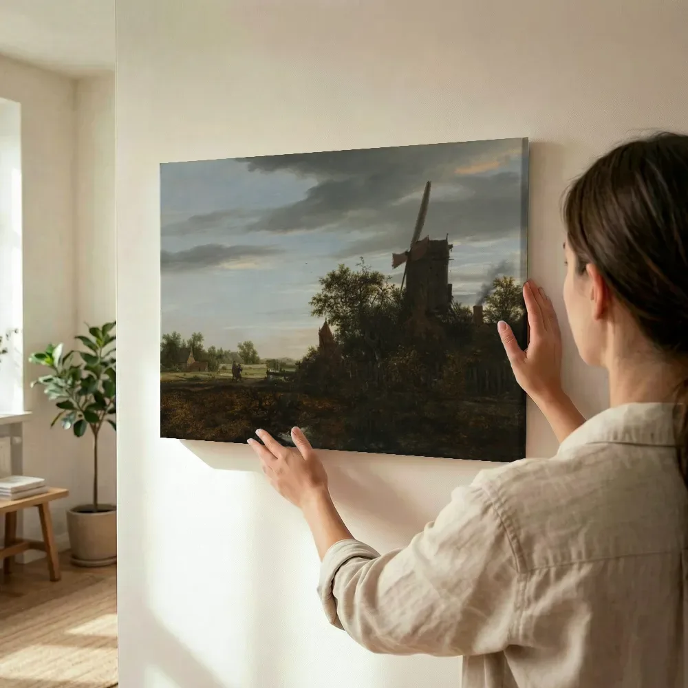 Sfeerimpressie: Landschap met een windmolen van Jacob van Ruisdael terwijl het wordt opgehangen