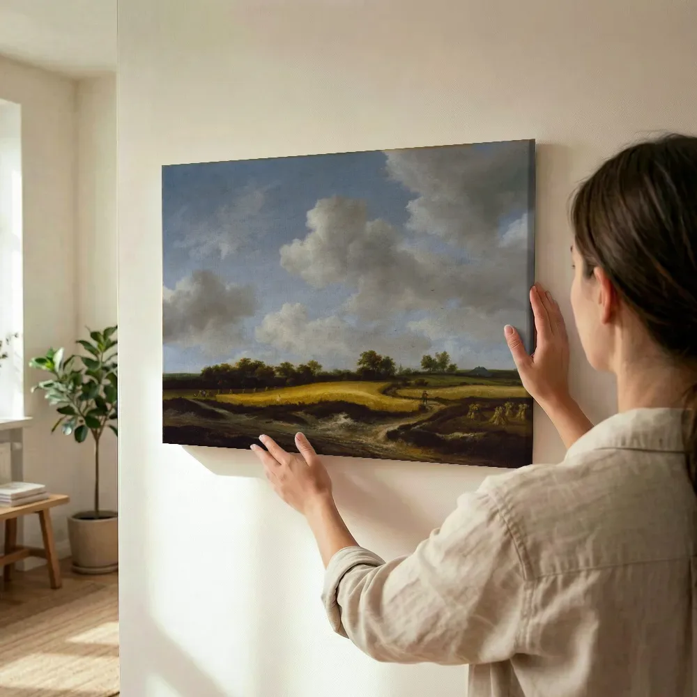 Sfeerimpressie: Landschap met een korenveld van Jacob van Ruisdael terwijl het wordt opgehangen